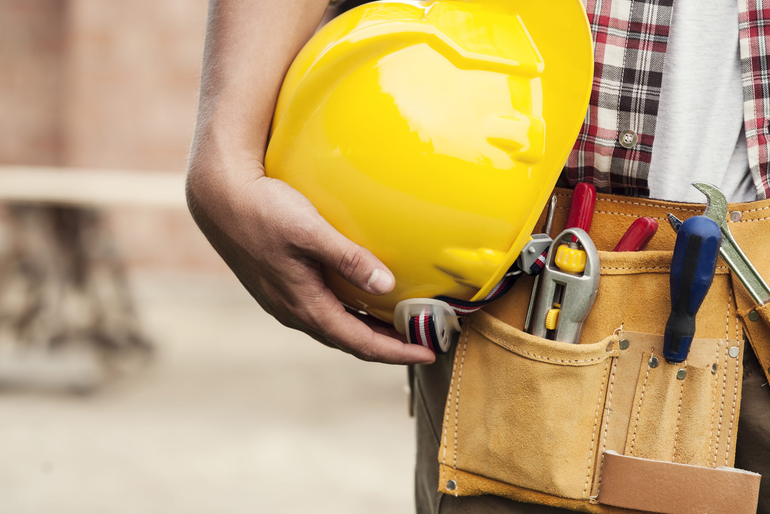 Construction worker holding hard hat