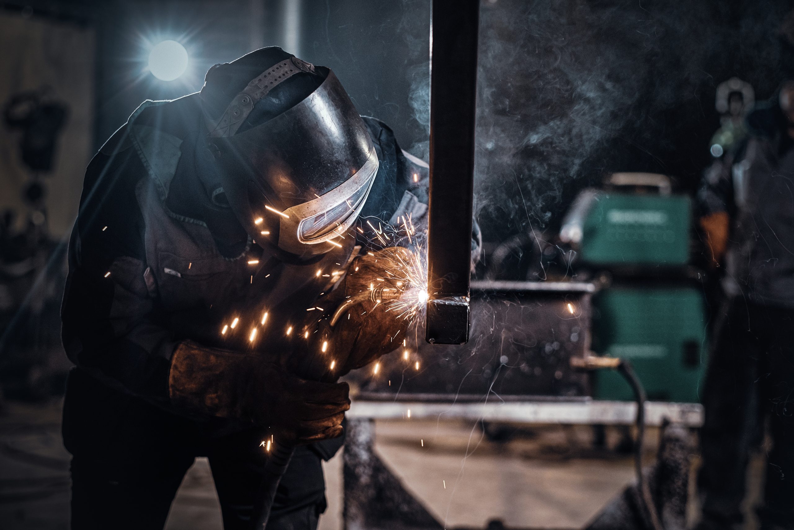 Worker welding in factory